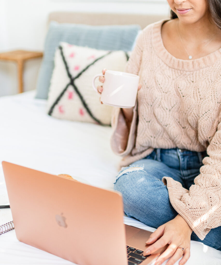 Woman sipping tea with laptop